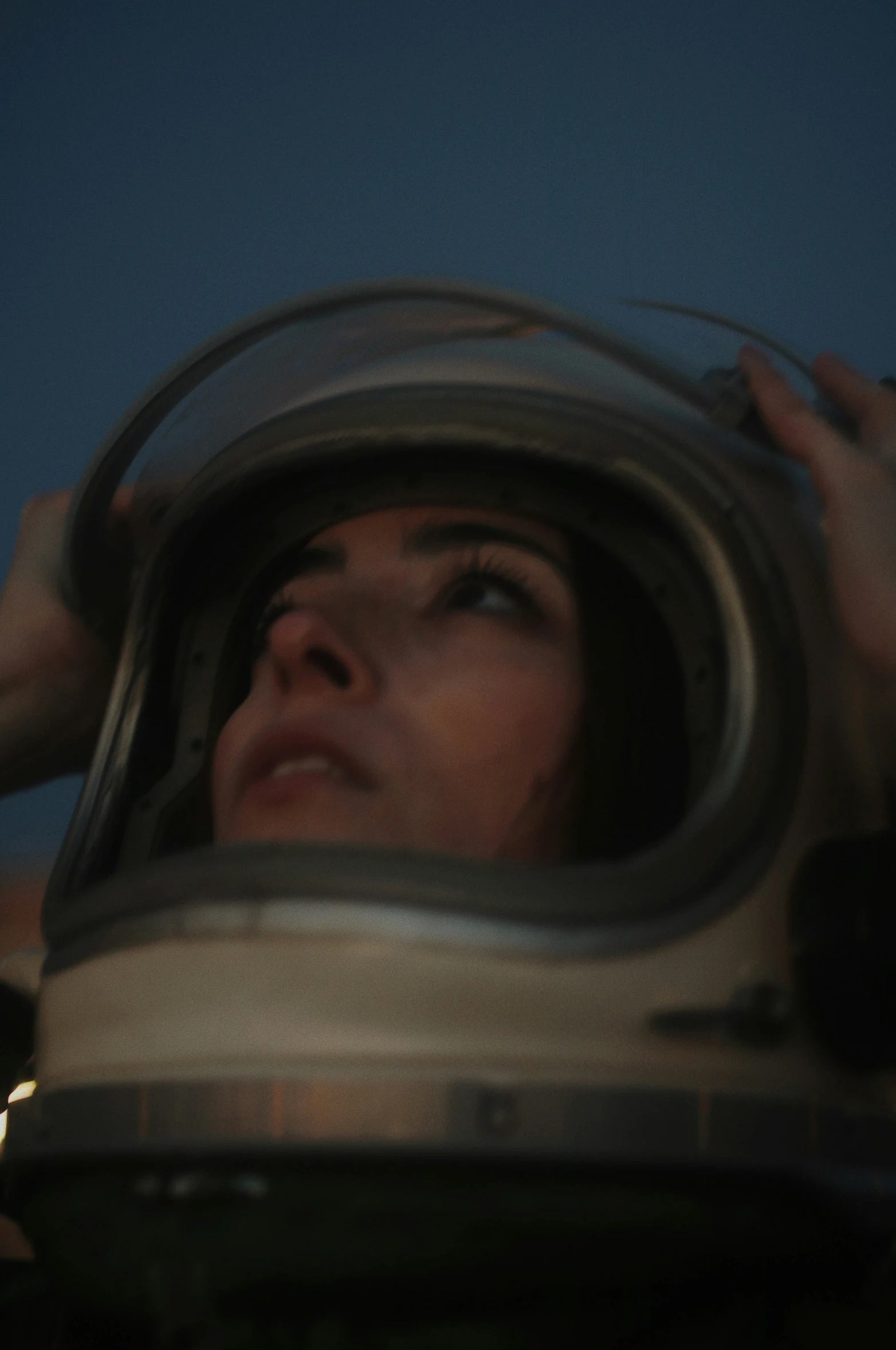 a young lady looking out of a spaceship helmet