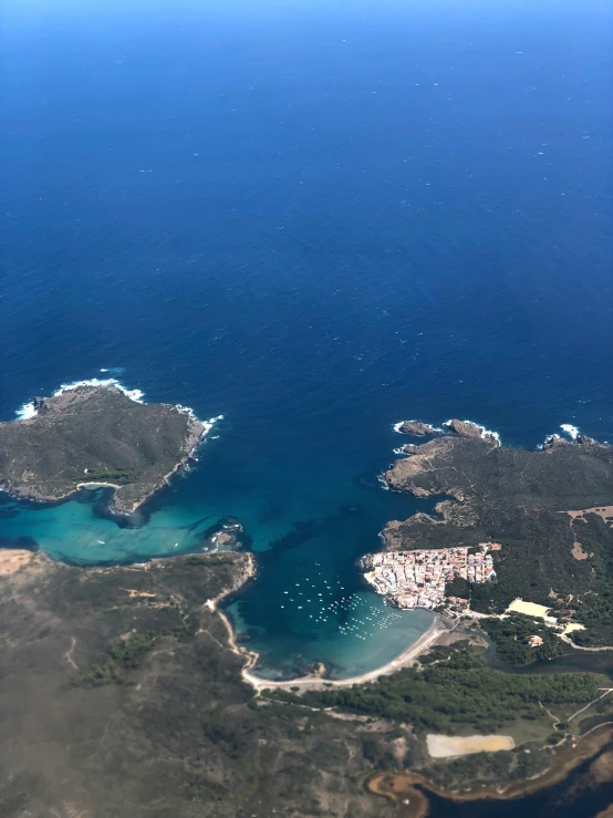 an aerial s of a large body of water with many small islands and trees