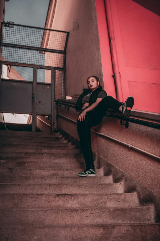 woman sitting on steps with skateboard on top