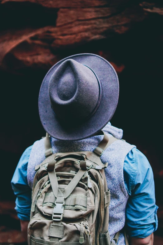 the back of the man with a hat on his head