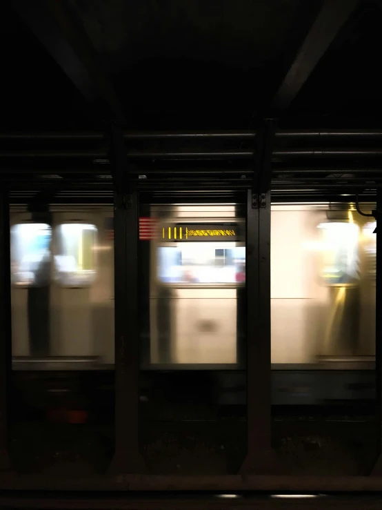 an empty subway car in the dark, speeding by