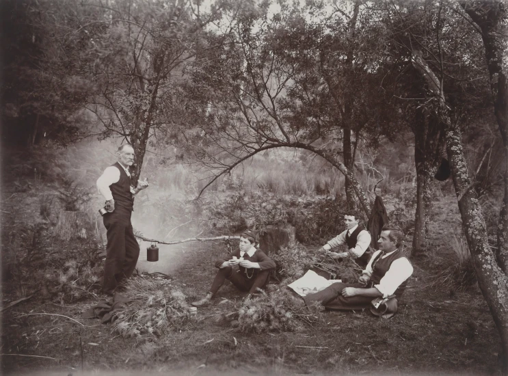 an old fashioned po of people sitting in the forest