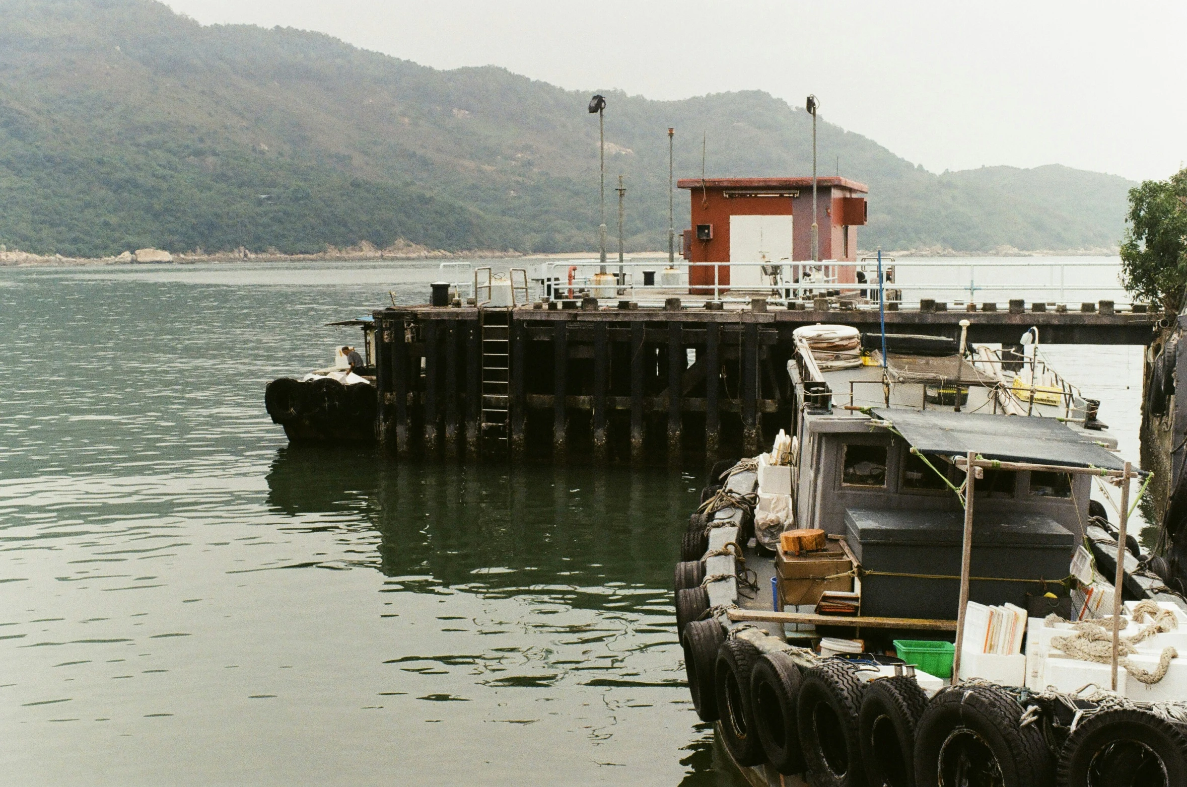 a boat is docked in the water at a dock