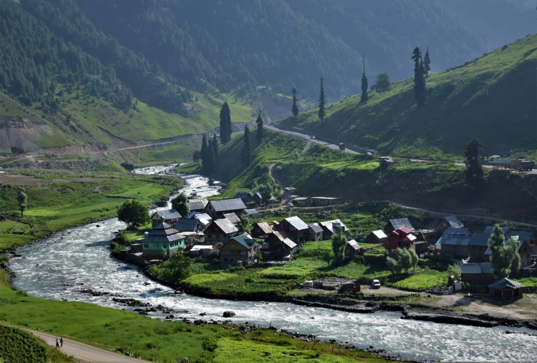 houses and land in the mountains near a river