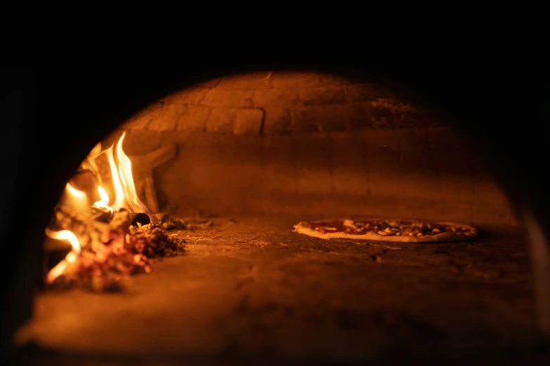 a pizza is cooked in a brick oven