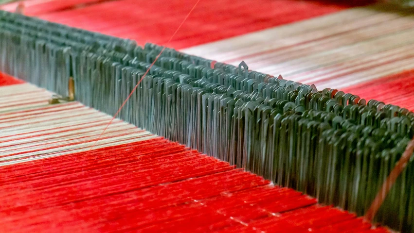 some red material is on the ground by thread