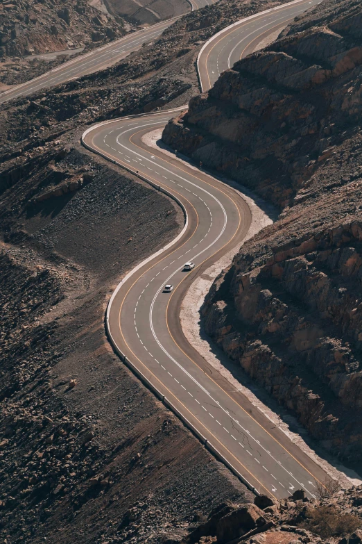 the curved road has white markings on it