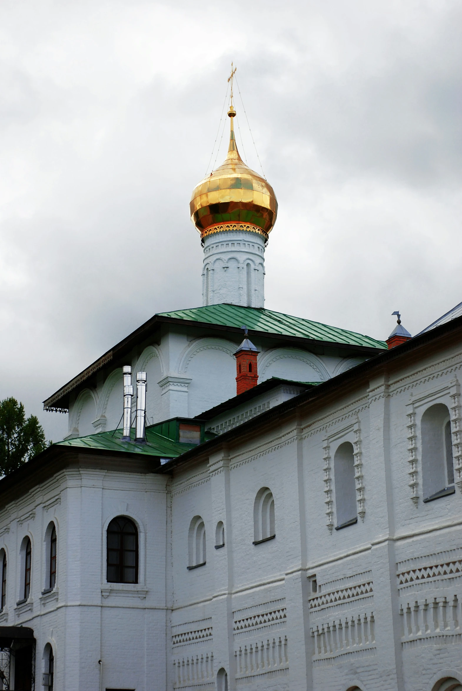 the white building has a gold dome on top