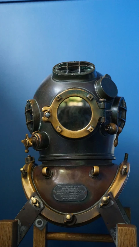 a antique diving helmet sitting on top of a table