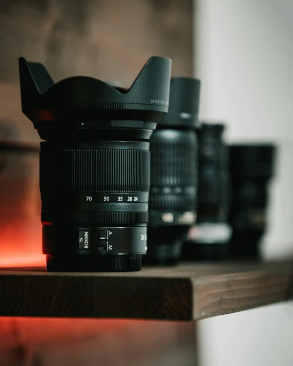 a large camera lens sitting on top of a wooden shelf