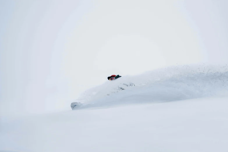 a person in a red jacket skiing down a slope