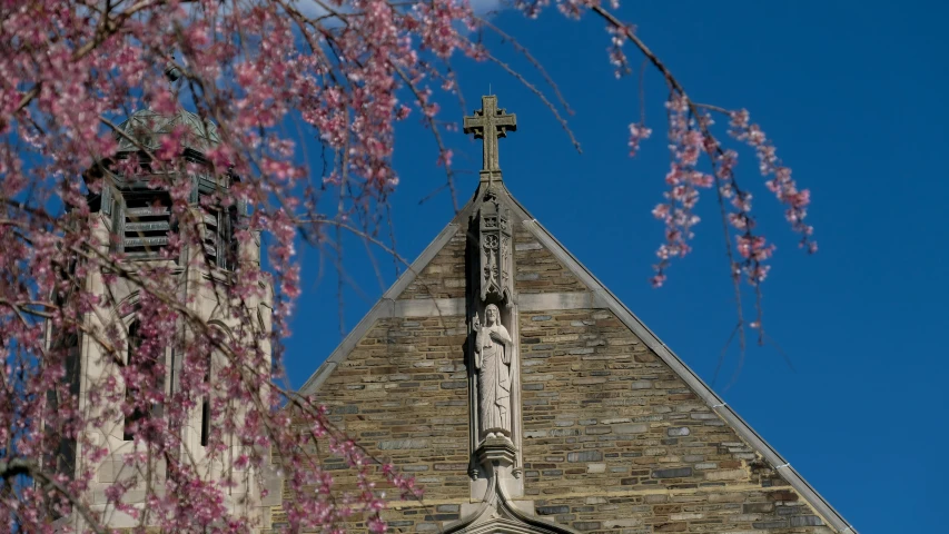 a large church steeple with a cross on it