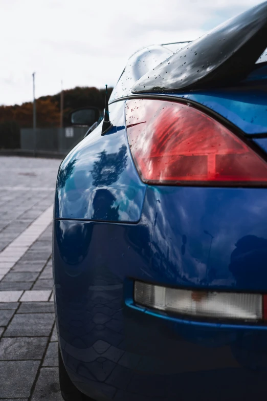 the tail end of a blue car is shown