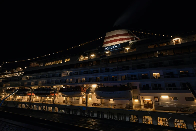 the cruise ship is lit up at night