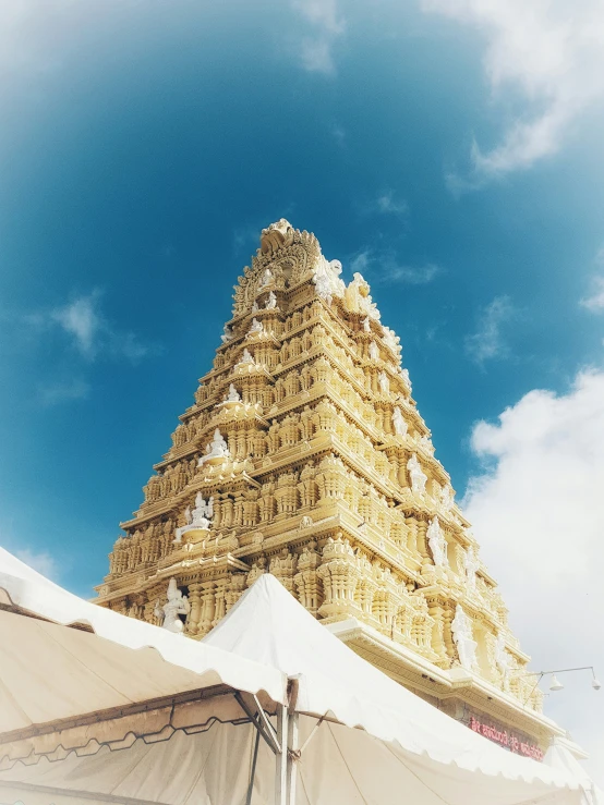 a large gold building with a blue sky in the background