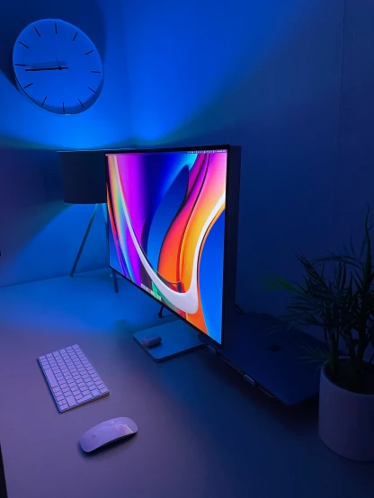 a computer on a table with blue lighting