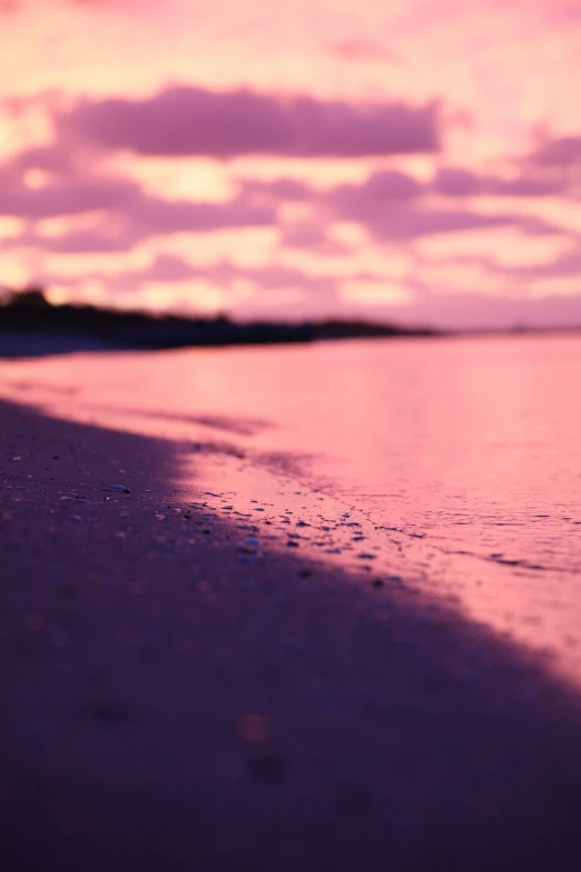 a body of water with a sand and sky