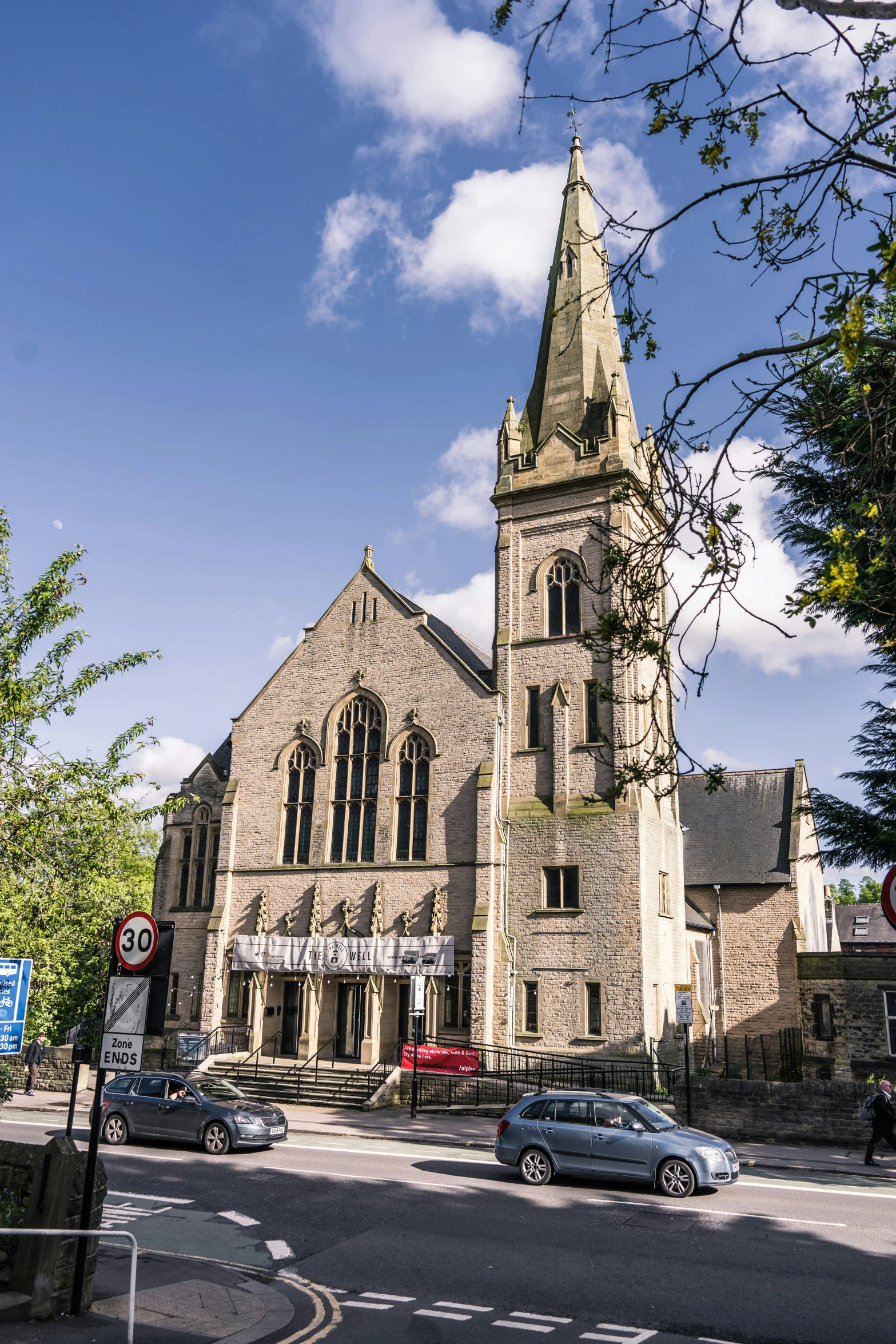 a church with a tower is shown behind a car