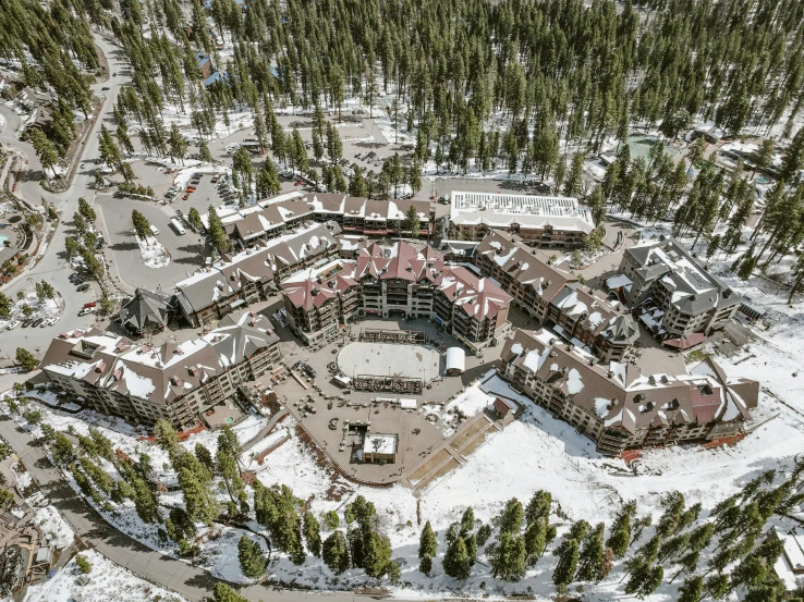 a snowy mountain town aerial po with a parking lot