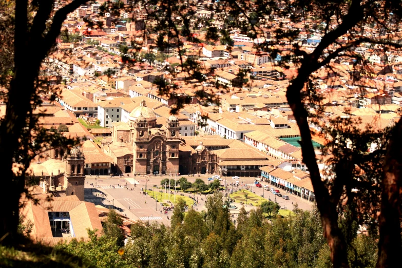 a large town with a church tower and trees