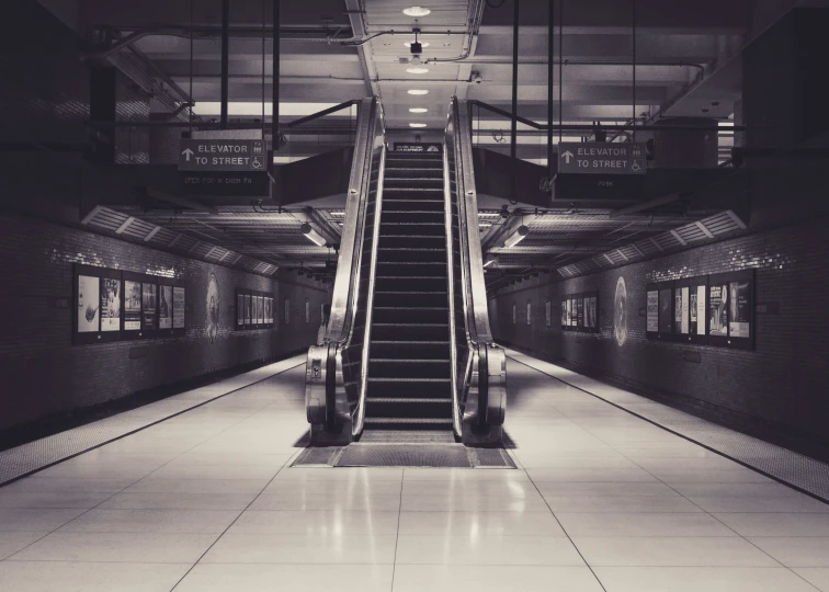 a black and white po of an escalator at a subway station