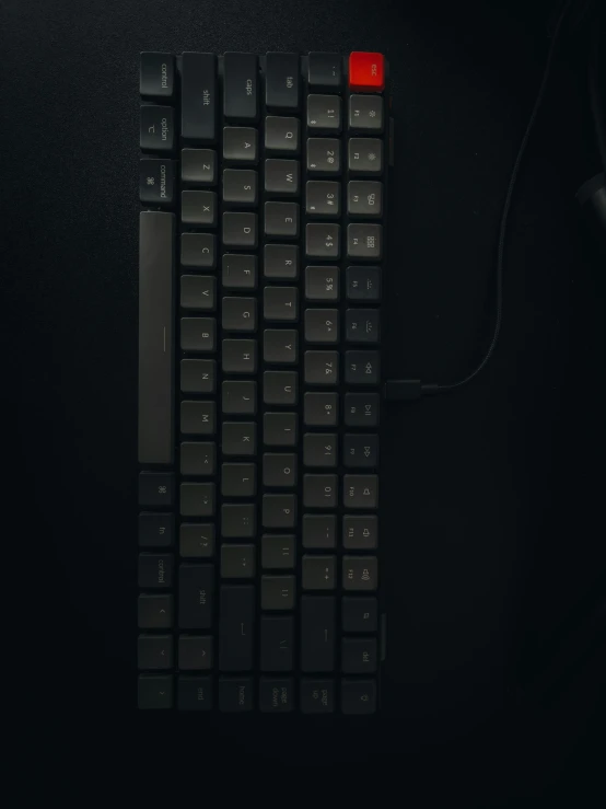 a computer keyboard with red key