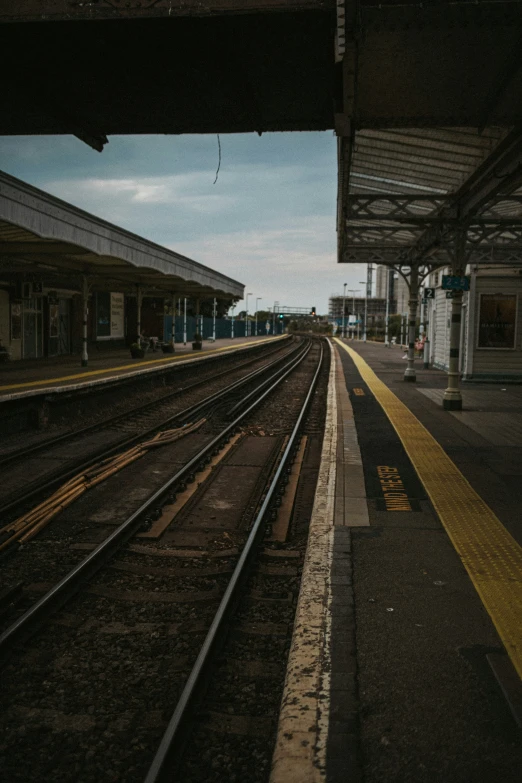 two sets of railroad tracks in a train station