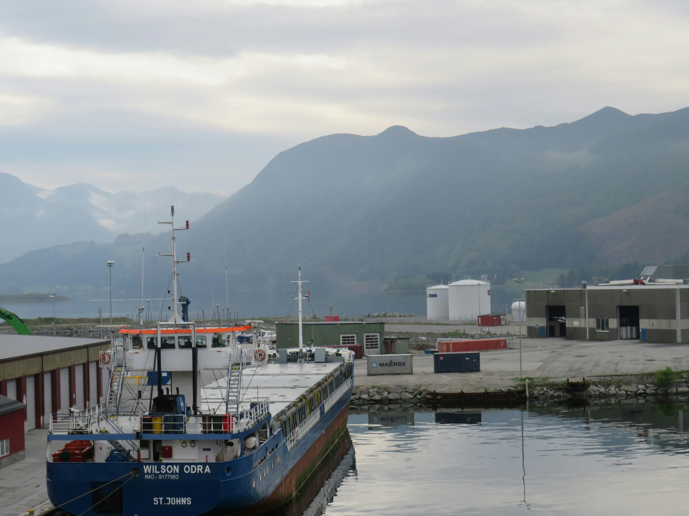 a blue and white boat is docked at the dock