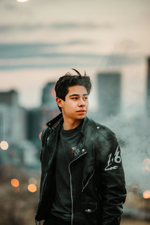 the young man is standing in front of a building