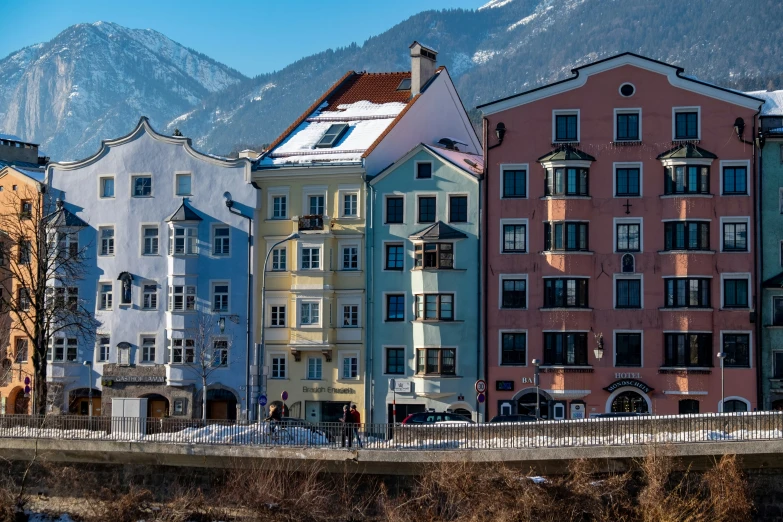 the mountain range is behind the row of houses