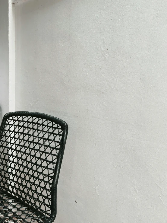 a black chair sits on top of a wall