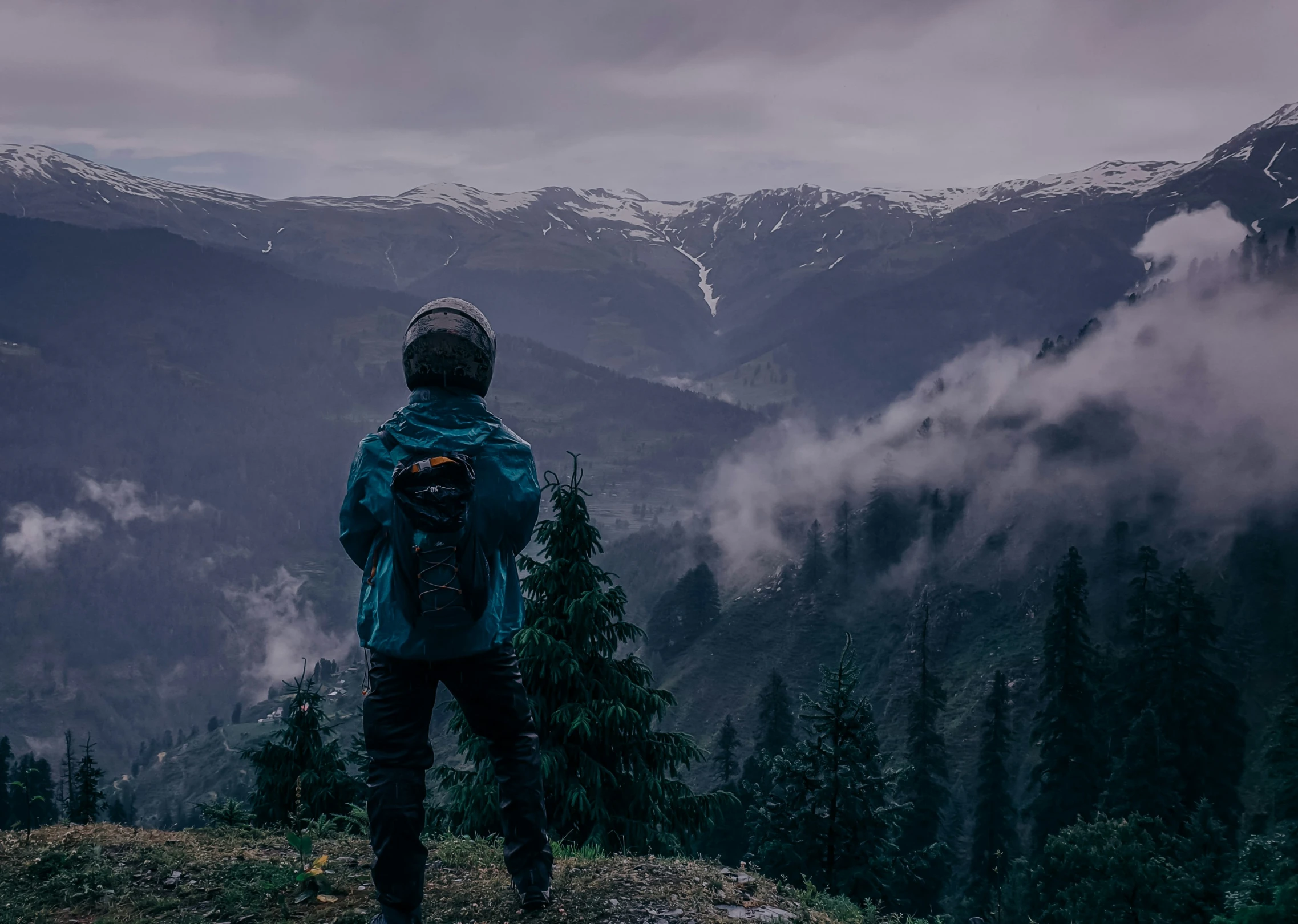 the person is watching the view from the top of the hill