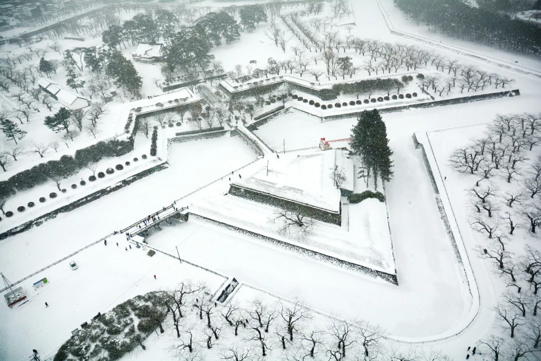 an aerial view shows a snow - covered city park