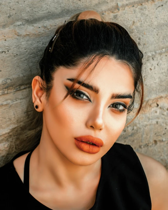 a close up of a person wearing orange lipstick