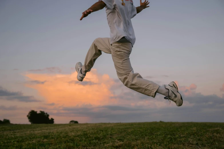 a young man is jumping up to catch the frisbee in the air