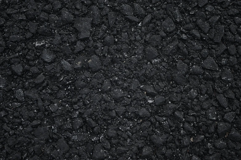 a textured black concrete background with little pebbles