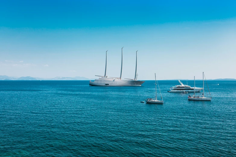 a number of sailboats on a body of water