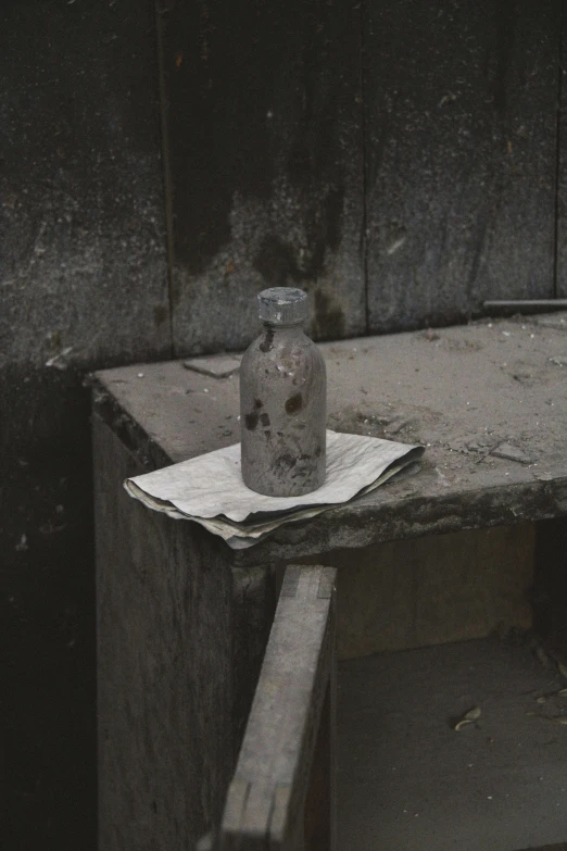 an empty bottle of medicine next to some tissues on the table