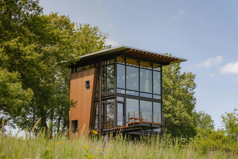 a large tall tower with a balcony near some trees