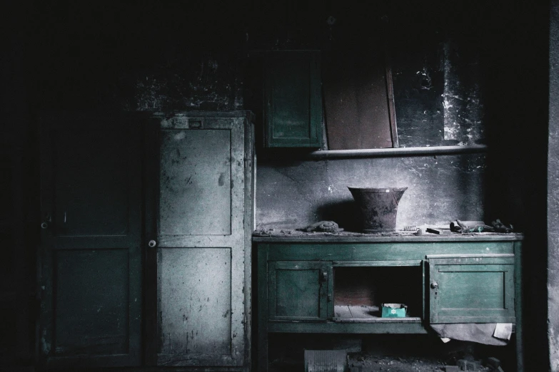 the dark kitchen with a dirty oven in it