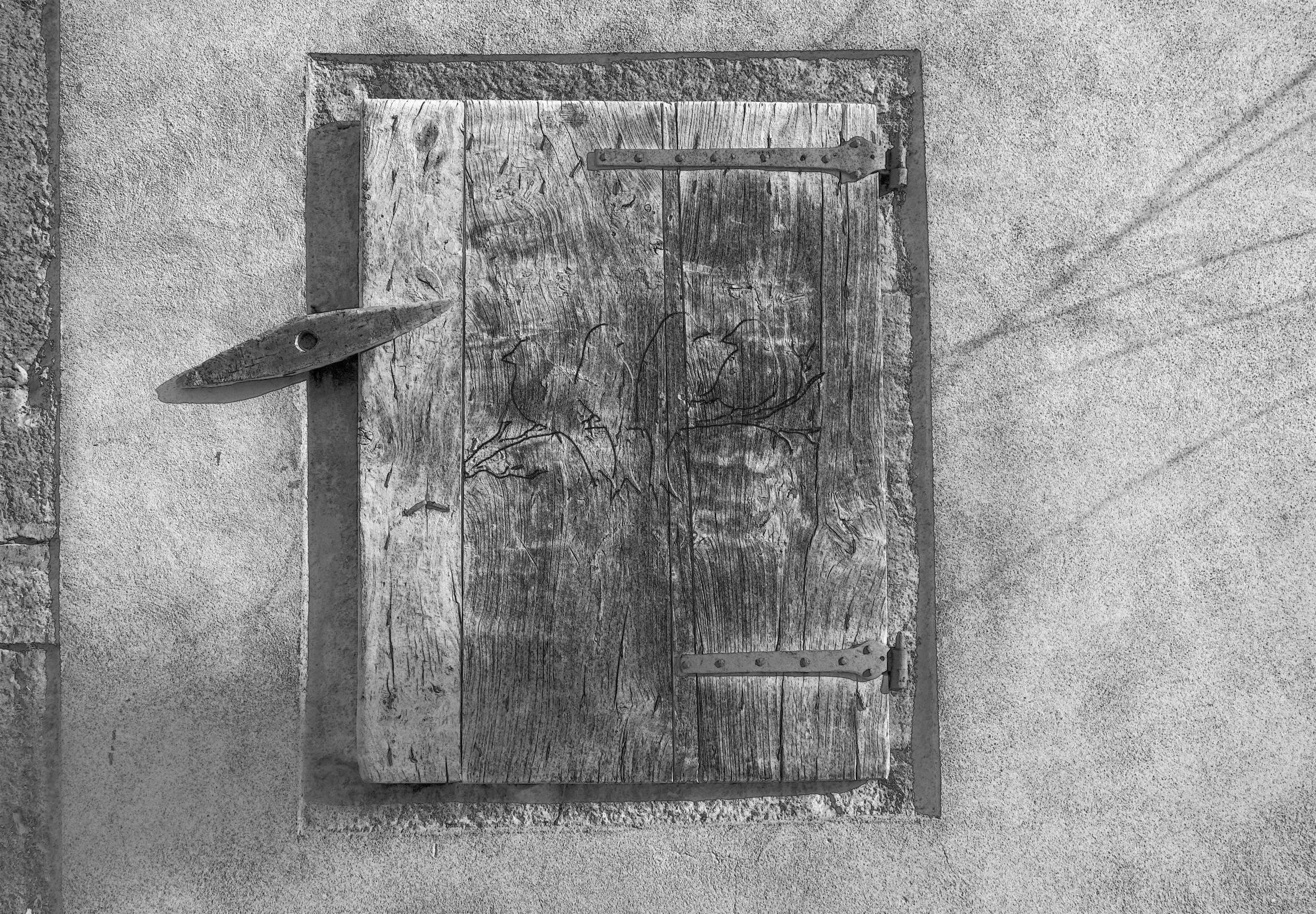 a wooden box sitting on the side of a building