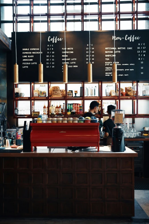 a person at a counter with coffee brewing