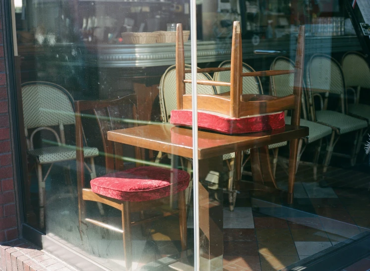 a table and chairs are in front of a window