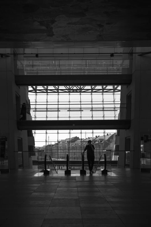 a person walking in an airport terminal with their luggage