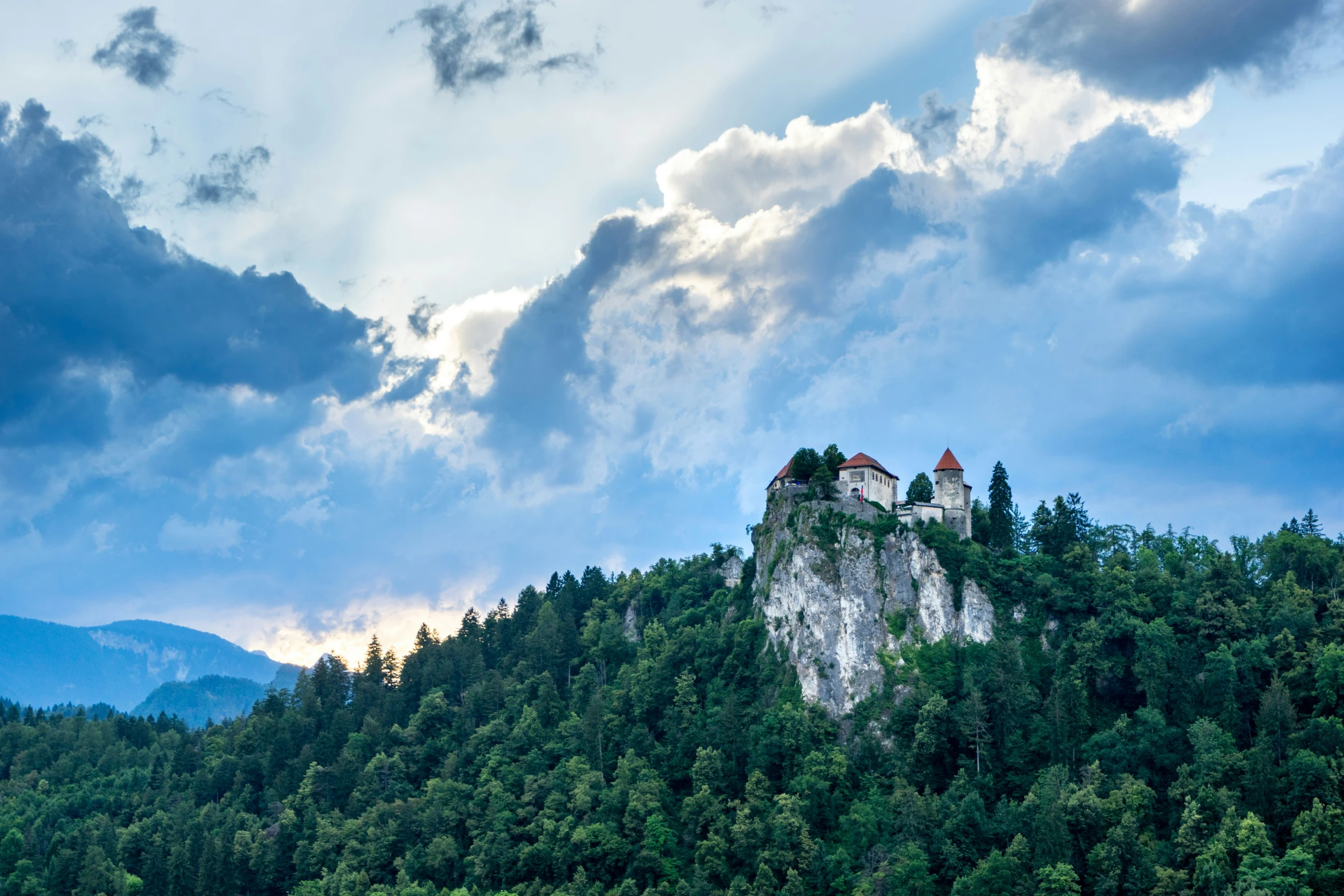 a castle on top of a rock covered hillside