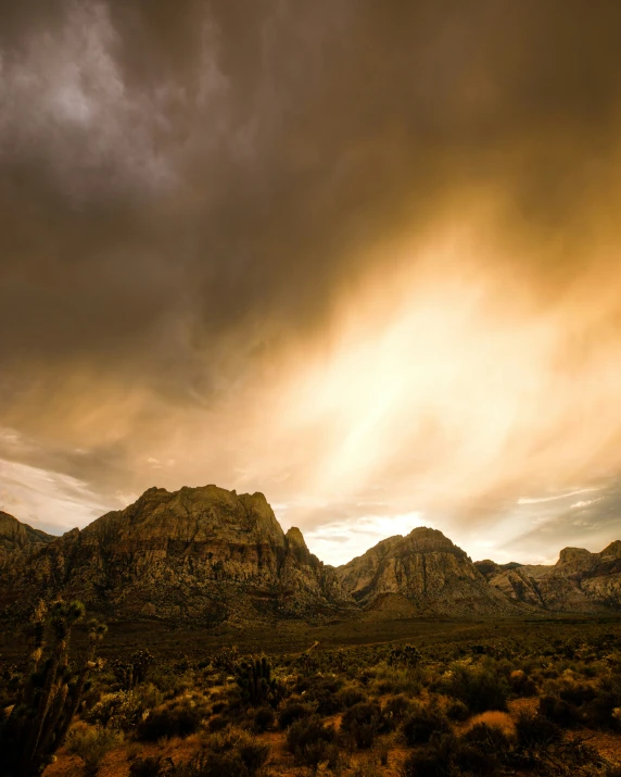 some very tall mountains in the sky with clouds above