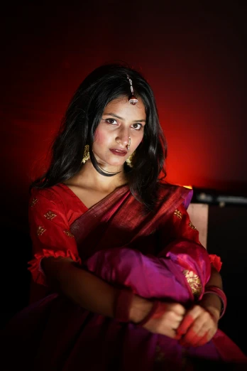 a young woman in an indian dress poses for a pograph