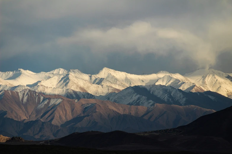 mountains are covered in snow and snow clouds