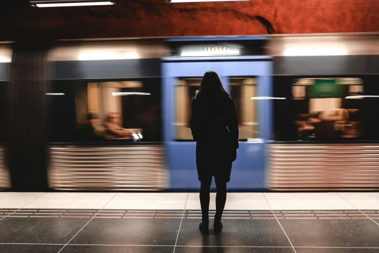 a girl is looking out the window of a train