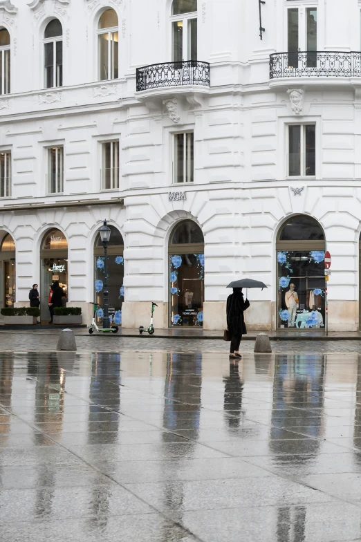 people are standing on the sidewalk with umbrellas